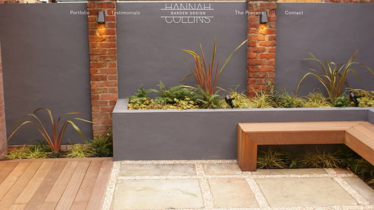 The Hannah Collins Garden Design homepage: an elegant logotype over a photograph of a landscaped garden with planting and a timber bench